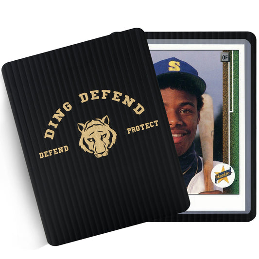 Ding Defend tiger design trading card shipping protector showing a black rigid protector with gold logo covering a standard 3.5 x 4.5 trading card