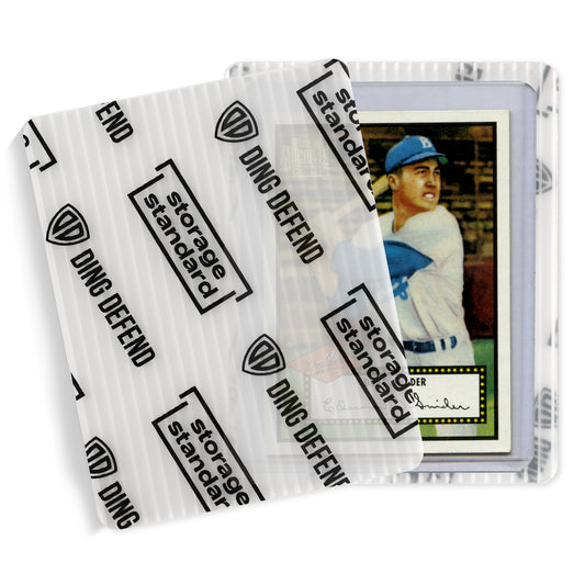 Close-up of a trading card in a top loader covered by a semi-transparent Ding Defend shipping protector